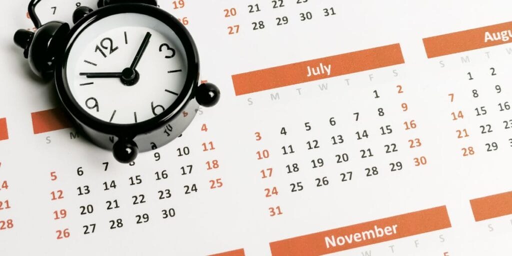 Alarm Clock Lying On Open Monthly Calendar Img