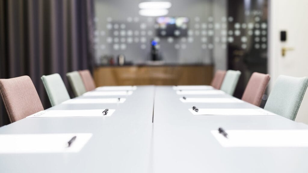 Empty Boardroom Table With Vacant Chairs 1600x900 1