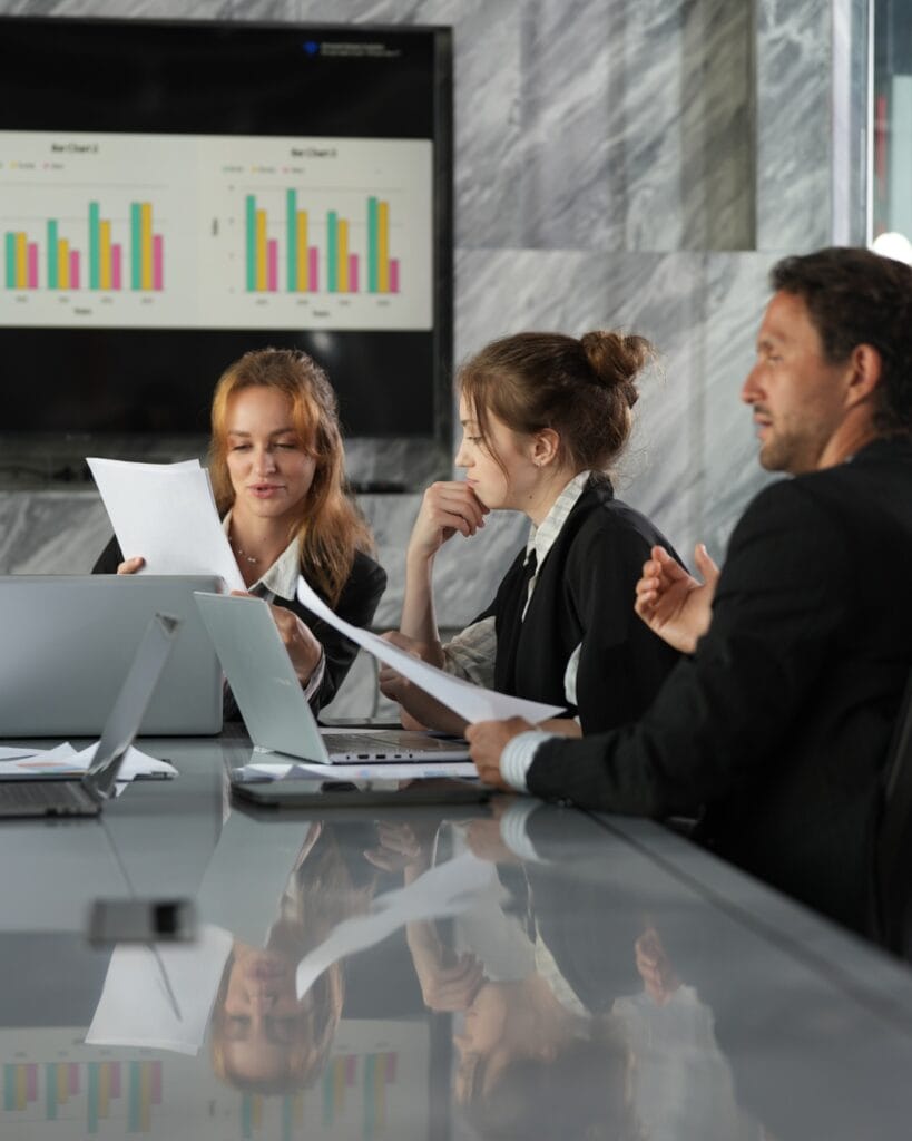 Executives Reviewing Data Metrics Boardroom 1200x1500 1
